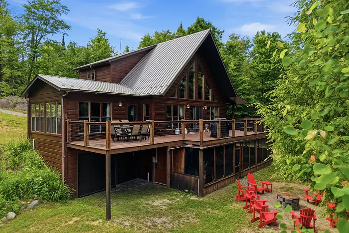 Wood chalet with a wraparound deck