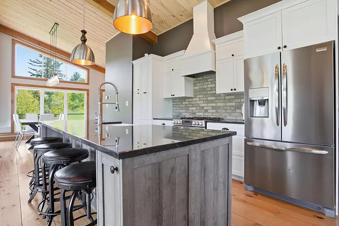 Kitchen island beneath a wood ceiling