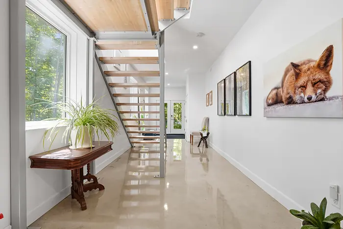 Open-riser staircase in a white entry