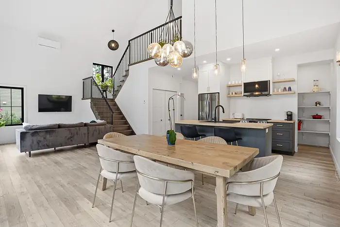 Dining table beside an open kitchen