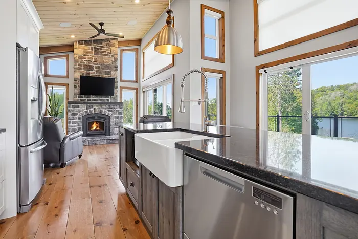 Kitchen with a fireplace and lake windows