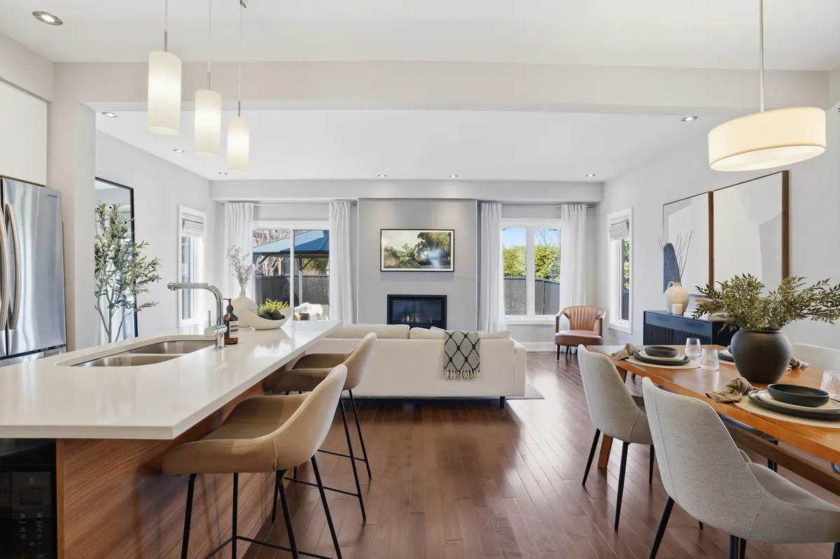 Open kitchen and dining area with a long counter and pendant lighting